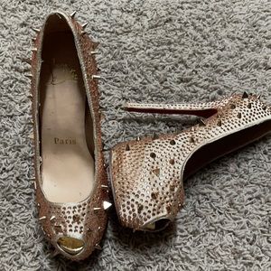 Gold spike Christian Louboutin heels.